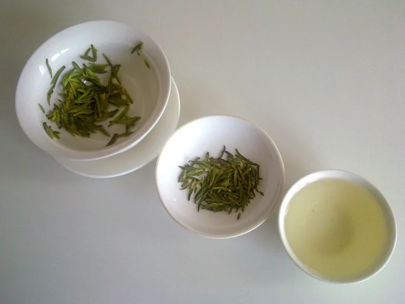 Chinese green tea shown as dry leaves, liquor and infused leaves for specification review