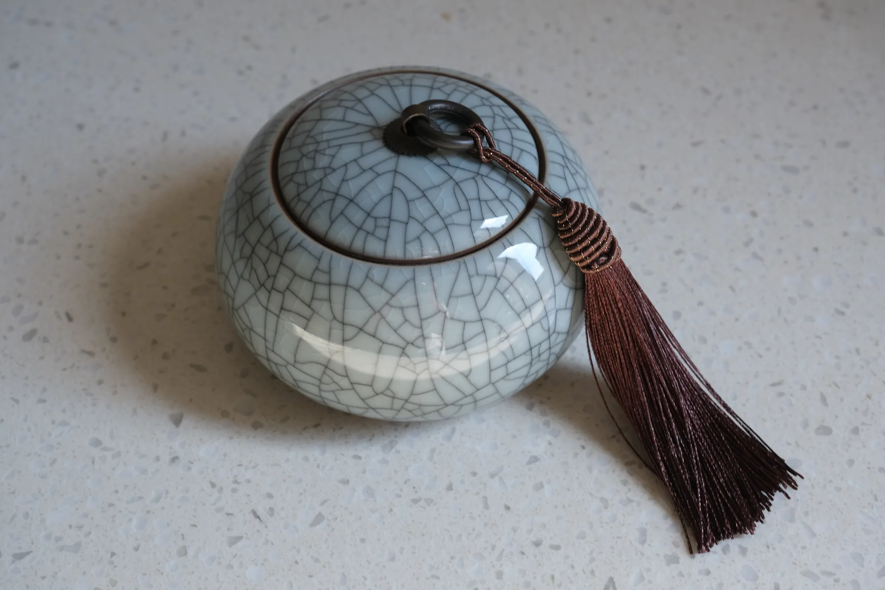 Chinese ceramic storage jar photographed as editorial context for protecting tea from light