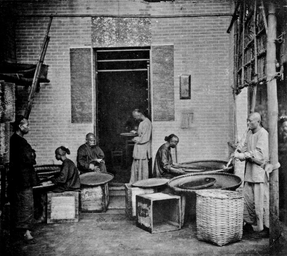 Historical photograph of tea sampling, sorting and export preparation at a tea house in Canton, China