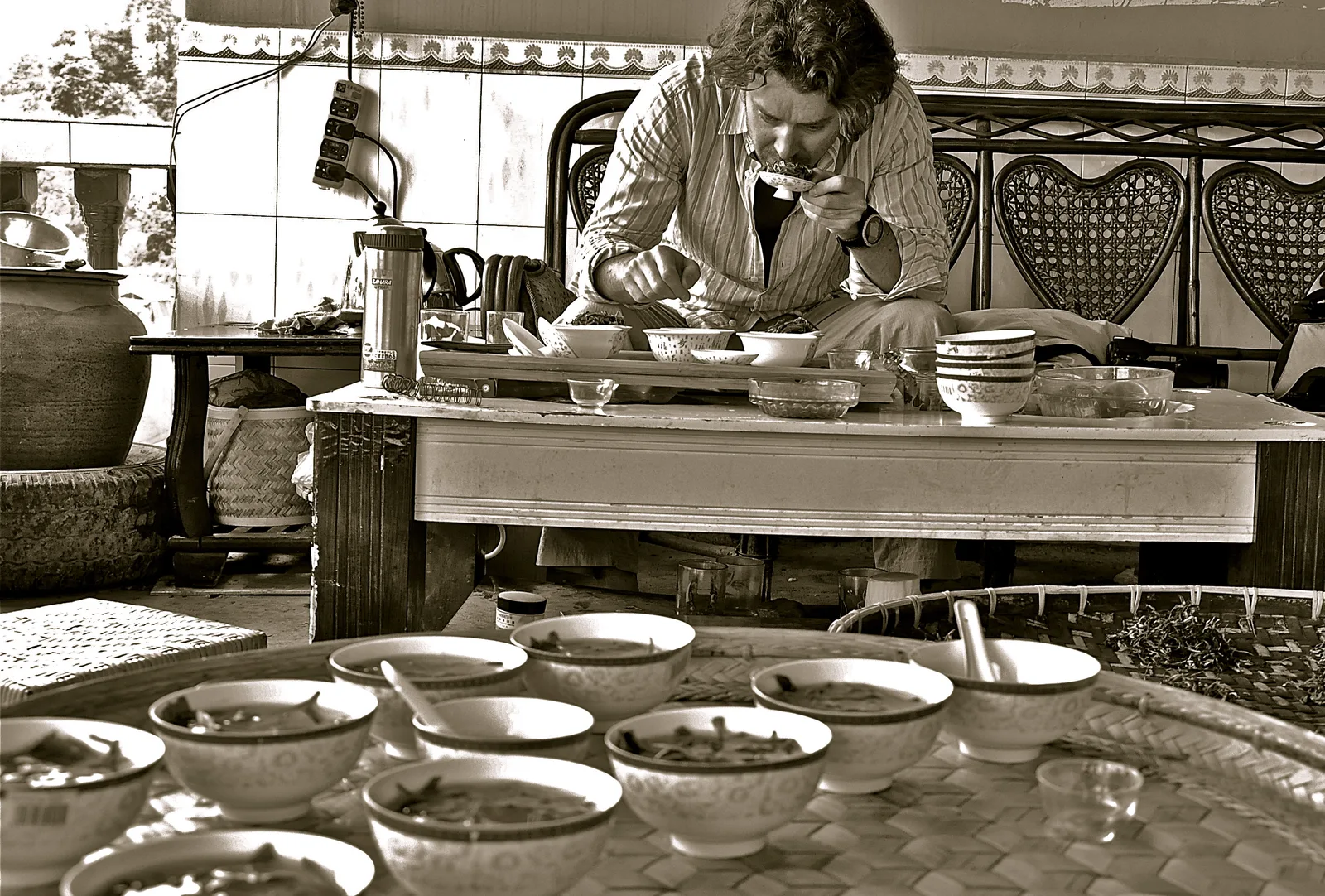 A tea evaluator comparing multiple tea samples in Xishuangbanna, Yunnan, China