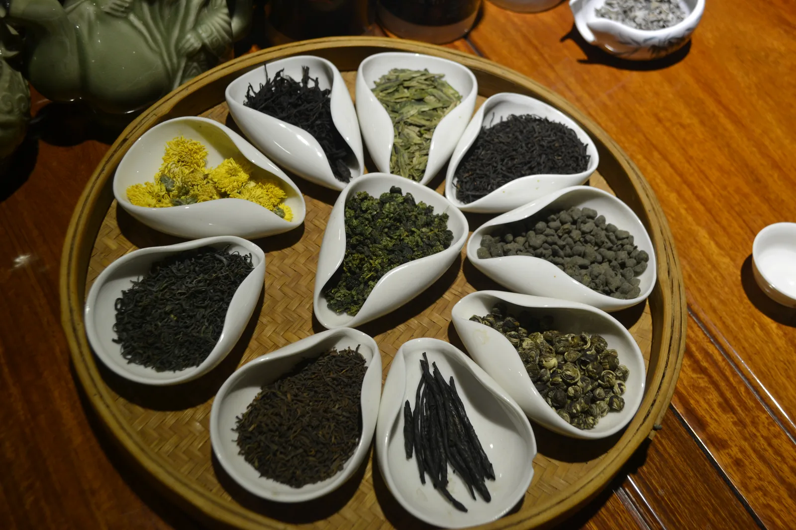 Loose Chinese tea samples displayed in presentation vessels in a Xi'an tea shop