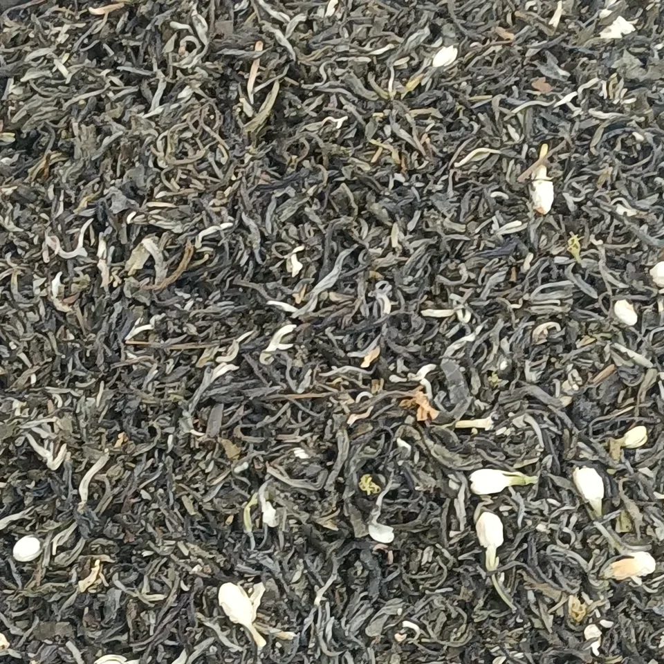 Genuine photograph of dried jasmine tea with visible tea leaves and jasmine blossoms