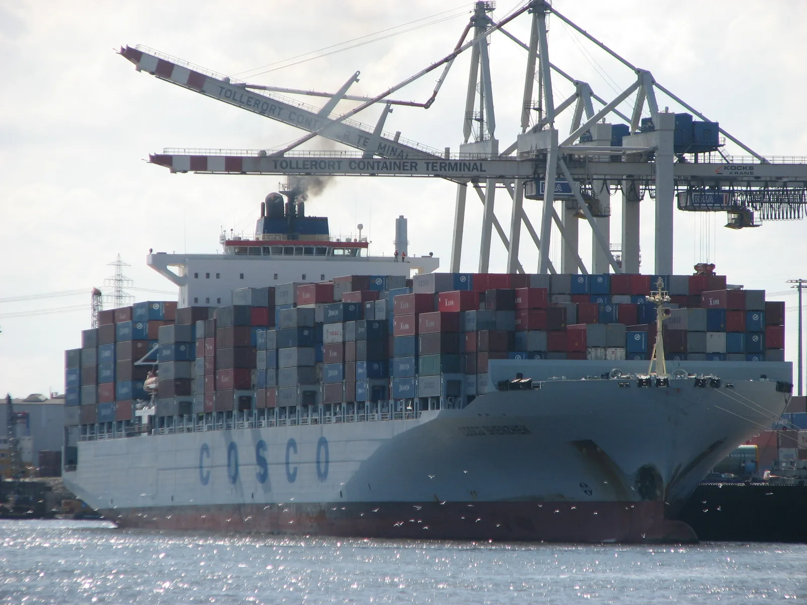 COSCO Shenzhen container ship alongside cranes at the Tollerort Container Terminal in Hamburg