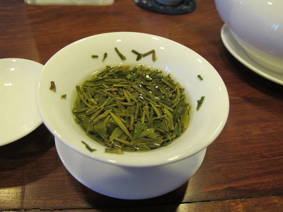 Genuine close-up photograph of dry Chinese Longjing green tea leaves