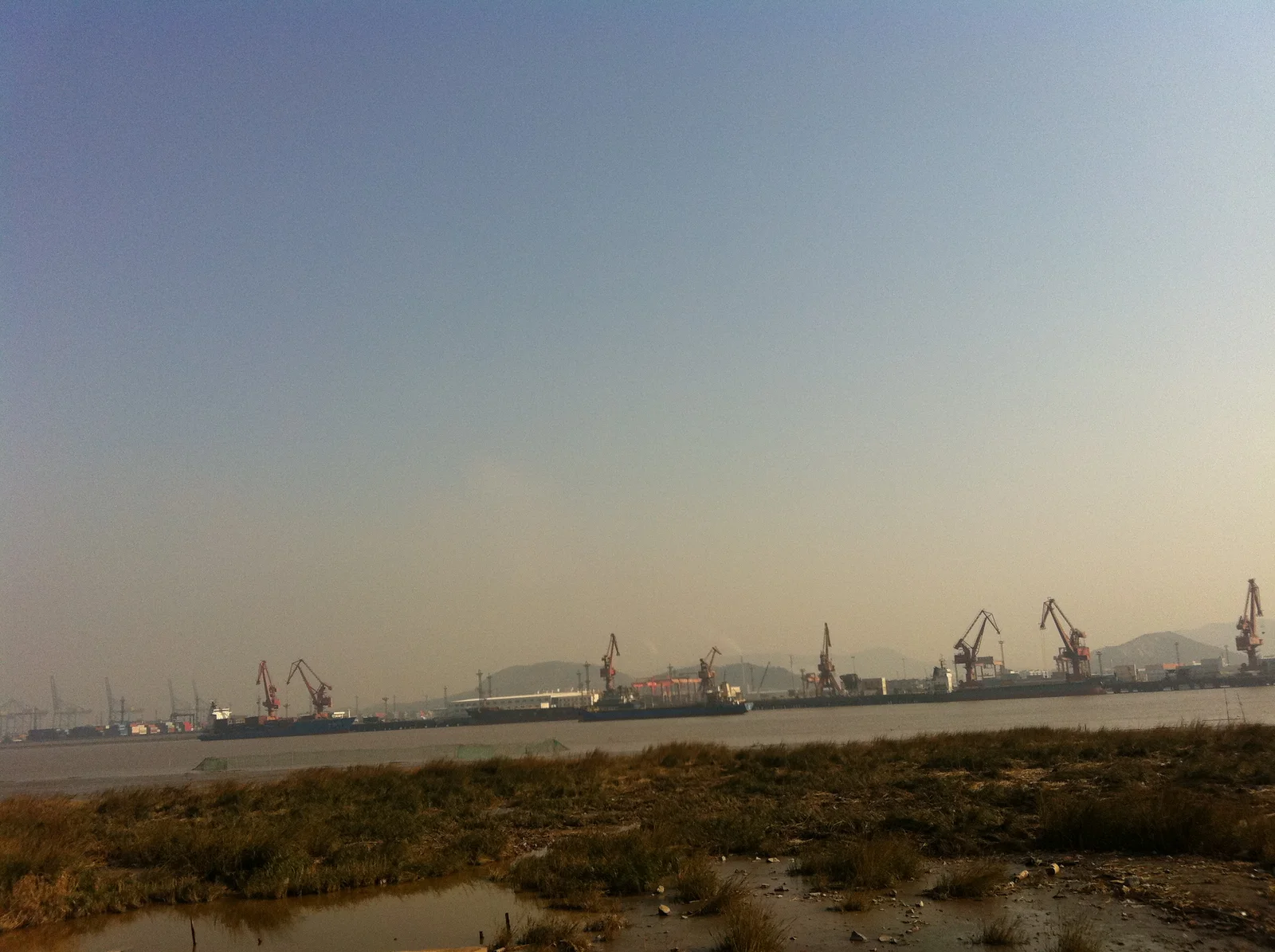 Containers and cargo-handling equipment at Beilun Port in Ningbo, China