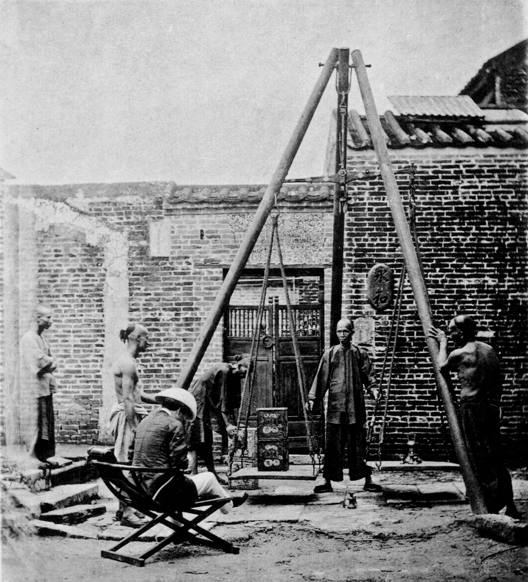 Historical photograph of Chinese tea chests being weighed for export