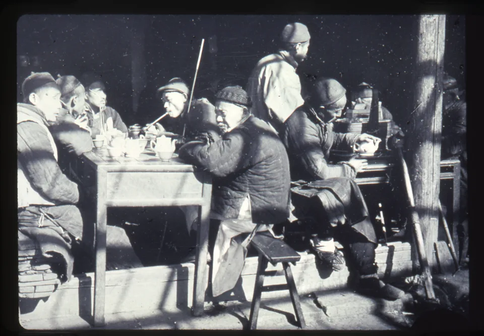 Historical photograph of men drinking tea at an open-front teashop in Changde, Hunan, China